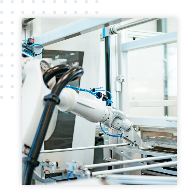 Robotic arm in a lab reaching for a tray of samples.
